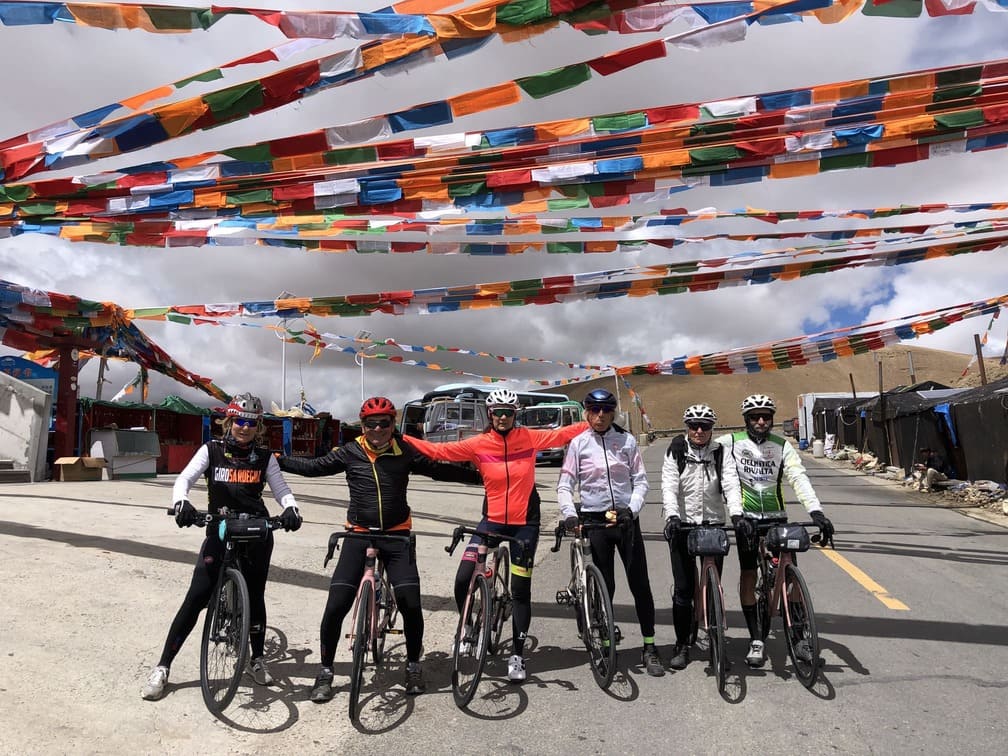 The bikers enjoying Tibet trip under beautiful Tibetan prayer flags